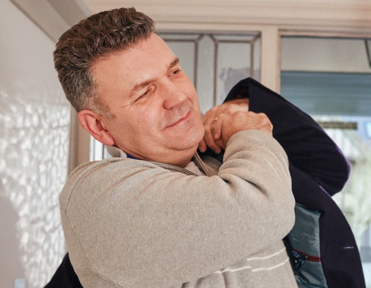 Man putting on his coat. Man putting on his coat.