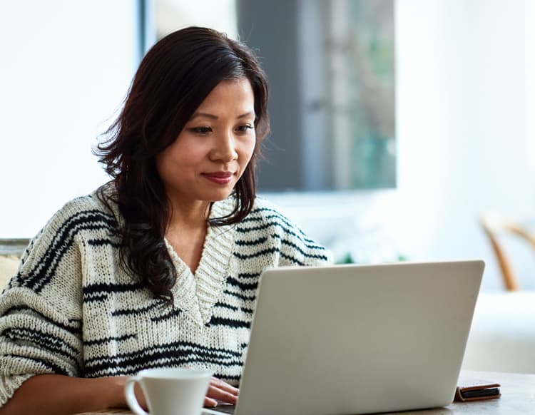 Woman looking at a laptop.