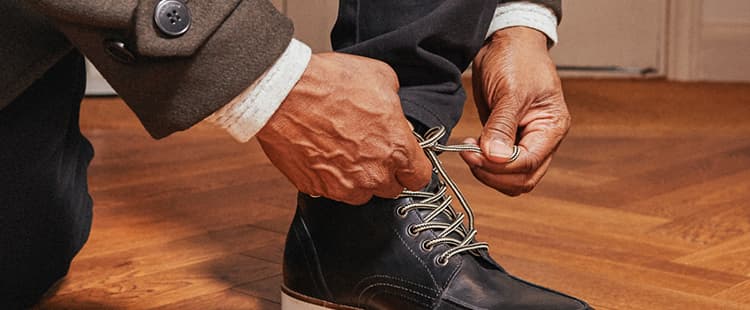 Man tying his shoes.