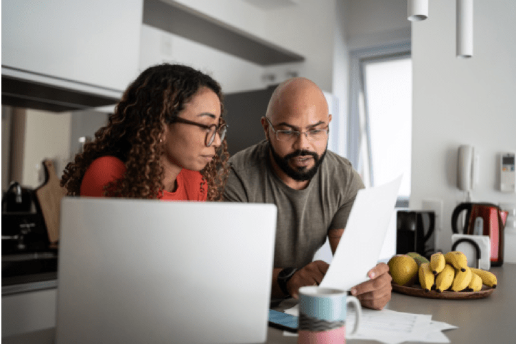 Two people looking over medical statements.