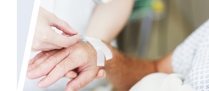 Doctor bandaging PI patient’s hand after GAMMAGARD LIQUID IV administration.